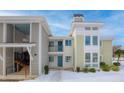 Modern condo building entrance with blue door and snowy ground at 267 Alexandra # 6, Mount Pleasant, SC 29464