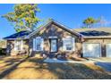 Brick ranch home with attached two-car garage at 303 Swamp Fox Ln, Goose Creek, SC 29445