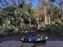 Fire pit on brick patio nestled in wooded area at 3100 Sonja Way, Mount Pleasant, SC 29466