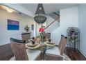 Glass-top dining table with four chairs, wine rack, and chandelier at 3157 Timberline Dr, Johns Island, SC 29455