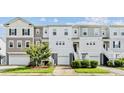 Three-story townhouses with attached garages and manicured lawns at 534 Mclernon Trace, Johns Island, SC 29455
