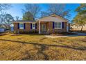 Brick ranch house with a well-maintained lawn and landscaping at 7643 Linsley Dr, North Charleston, SC 29418