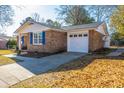 Brick ranch home with attached garage and driveway at 7643 Linsley Dr, North Charleston, SC 29418