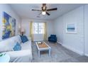Bright living room with light walls, comfy couch, and ceiling fan at 7643 Linsley Dr, North Charleston, SC 29418