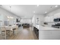 Open concept kitchen with island and adjacent living area at 117 Wonder Sol Way, Summerville, SC 29485