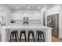 Modern kitchen with white cabinets, large island, and stainless steel appliances at 117 Wonder Sol Way, Summerville, SC 29485