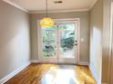Sunlit dining area with hardwood floors and French doors leading to a private patio at 1378 Cassidy Ct # B, Mount Pleasant, SC 29464