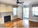 Bright living room featuring hardwood floors, a fireplace, and access to a patio at 1378 Cassidy Ct # B, Mount Pleasant, SC 29464