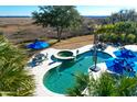 Elevated view of luxury pool, spa, and patio area at 1563 Headquarters Plantation Dr, Johns Island, SC 29455