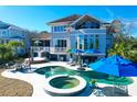 Luxury pool and spa with patio furniture and umbrellas at 1563 Headquarters Plantation Dr, Johns Island, SC 29455