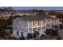 Elevated view of a two-story house, showcasing its architectural details and landscaping at 1646 Red Tide Rd, Mount Pleasant, SC 29466