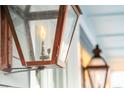 Close-up of an ornate, gas-lit lantern on the front porch at 1646 Red Tide Rd, Mount Pleasant, SC 29466