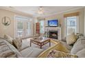Spacious living room with fireplace, hardwood floors, and access to a deck at 209 Charleston Blvd, Isle of Palms, SC 29451