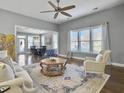 Bright and airy living room with hardwood floors and comfy furniture at 3002 Cross Vine Ln, Summerville, SC 29483