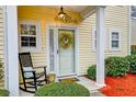 Inviting front porch with rocking chair and wreath on front door at 3312 Middlesboro Ave, Summerville, SC 29485