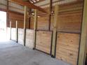 Interior of a barn with several horse stalls made of light-colored wood at 369 Groomsville Rd, Moncks Corner, SC 29461