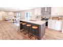 Modern kitchen with white cabinets, gray island, and stainless steel appliances at 414 Caties View Way, Moncks Corner, SC 29461