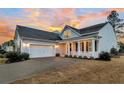 Gray siding two-story house, white porch, and a two-car garage at 559 Tidewater Chase Ln, Summerville, SC 29486