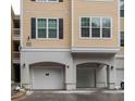 Two-car garage with white doors and neutral colored building at 60 Fenwick Hall Allee # 924, Johns Island, SC 29455