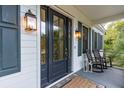 Elegant front entrance with a dark blue door and stylish lanterns at 6800 Back Bay Dr, Isle of Palms, SC 29451