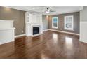 Bright living room featuring hardwood floors and a white fireplace at 7228 Mossy Creek Ln, Hanahan, SC 29410