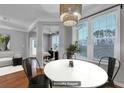 Virtually staged dining area with hardwood floors and modern chandelier at 1034 Rosewood Ln, Mount Pleasant, SC 29464