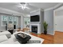 Virtually staged living room with fireplace and hardwood floors at 1034 Rosewood Ln, Mount Pleasant, SC 29464