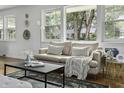 Bright living room features a beige sofa and large windows at 1134 Mim Ave, Charleston, SC 29407
