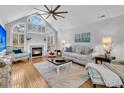 Spacious living room with hardwood floors, fireplace, and large windows at 1449 Waterside Ct, Mount Pleasant, SC 29464