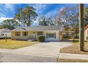Ranch style home with a carport, and mature trees at 1513 Secessionville Rd, Charleston, SC 29412