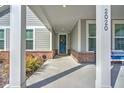 Front porch with white columns and blue door at 2020 Parish House Cir, Johns Island, SC 29455