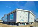Single-story home with gray siding and large windows at 377 Seven Acres Rd, Saint George, SC 29477
