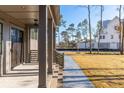 Covered porch with gray columns and brick steps leading to the home's entrance at 3917 Delinger Dr, Mount Pleasant, SC 29466