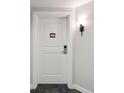 White apartment door with a simple design and a numbered placard at 5804 Palmetto Dr # A-405/407, Isle of Palms, SC 29451