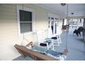 Screened porch with rocking chairs and porch swing at 603 Portia St, Edisto Beach, SC 29438