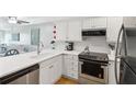 Modern white kitchen with stainless steel appliances at 7000 Palmetto Dr # 3F, Isle of Palms, SC 29451