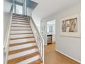 Interior wood and white staircase with light flooring at 7000 Palmetto Dr # 3F, Isle of Palms, SC 29451