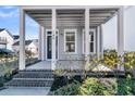 Covered front porch with brick steps and landscaping at 760 Myrtle Branch St, Summerville, SC 29486
