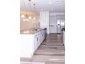 Modern kitchen with gray cabinets, granite countertops, and island at 9806 Sickle Dr, Ladson, SC 29456