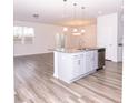 Open concept kitchen with island and granite countertops at 9806 Sickle Dr, Ladson, SC 29456
