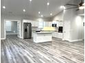 Open kitchen with island, stainless steel appliances, and hardwood floors at 100 Del Ray Dr, Walterboro, SC 29488
