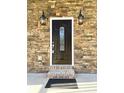 Elegant dark brown front door with glass accents and stone surround at 104 Del Ray Dr, Walterboro, SC 29488
