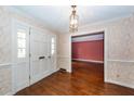 Hardwood floor entryway with white door and view to living room at 108 Fairway Dr, Summerville, SC 29483