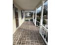 Brick paved porch with white railings at 206 Dora Dr, Saint George, SC 29477