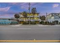 Two-story beach home with palm trees and ocean views at 309 Palmetto Blvd, Edisto Island, SC 29438