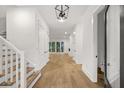 Bright entryway with hardwood floors and staircase leading upstairs at 5105 St George Ln, Hollywood, SC 29449