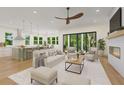 Open living room and kitchen with light and airy feel, fireplace, and large windows at 5105 St George Ln, Hollywood, SC 29449