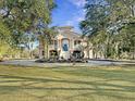 Beautiful home nestled amongst mature trees with a large yard at 6411 China Back Ln, Meggett, SC 29449