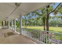 Spacious porch overlooking a tranquil backyard and pond at 820 Pineneedle Way, Charleston, SC 29492