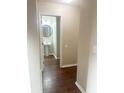 Small bathroom with pedestal sink and dark hardwood floors at 8781 Red Oak Dr, North Charleston, SC 29406